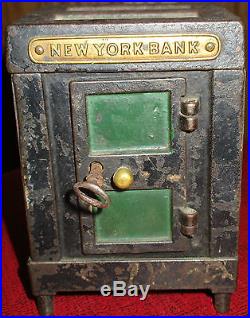 ANTIQUE CAST IRON AND METAL NEW YORK SAFE BANK WITH KEY COIN STIILL BANK