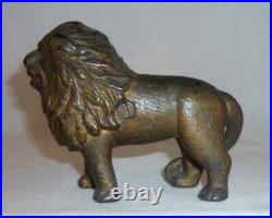 Antique Gold Colored Cast Iron Still Penny Bank Standing Lion With Tail Right