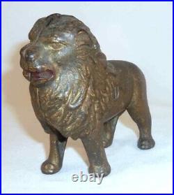 Antique Gold Colored Cast Iron Still Penny Bank Standing Lion With Tail Right