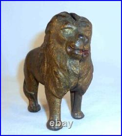 Antique Gold Colored Cast Iron Still Penny Bank Standing Lion With Tail Right