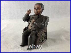 Antique Man Sitting In A Chair Mechanical Bank