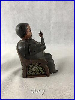 Antique Man Sitting In A Chair Mechanical Bank