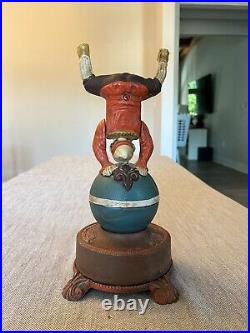 Clown on Globe Cast Iron Mechanical Bank