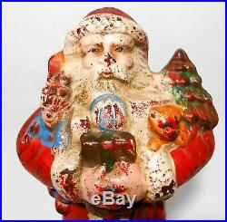 EARLY 20TH C ANTIQUE CAST IRON SANTA CLAUS HOLDING GIFTS COIN BANK, WithORIG PAINT