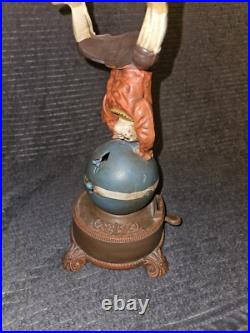 J & E Stevens Clown on Globe Cast Iron Mechanical Coin Bank Spinning Acrobat