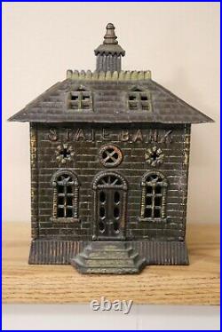 STATE BANK cast iron building bank with solid door circa 1910 8+ inches tall