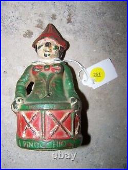 Vintage Cast Iron Red Suited Pinocchio on a Drum Bank Original Paint